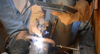 A man welds steel beams